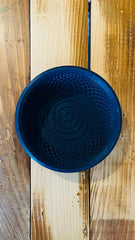 a blue bowl sitting on top of a wooden table